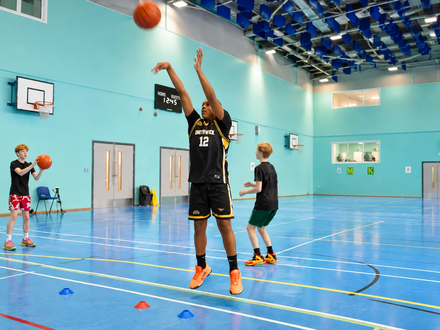 A Holly Lodge player practising their shooting technique in the sports hall