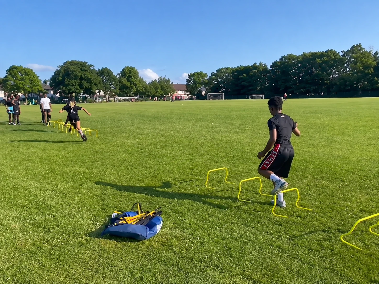 Holly Lodge pupils completing an outdoor hurdle drill before school